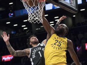 Indiana Pacers center Al Jefferson (25) goes to the basket against Brooklyn Nets guard D'Angelo Russell (1) during the first half of an NBA basketball game Wednesday, Feb. 14, 2018, in New York.