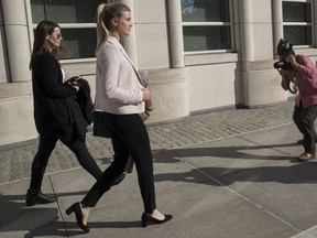 Tennis star Eugenie Bouchard, second from left, is photographed as she leaves Brooklyn Federal court with her mother, Wednesday, Feb. 21, 2018, in New York. Bouchard testified during her negligence lawsuit against the United States Tennis Association that a wet floor caused her to slip and fall inside a locker room at the 2015 U.S. Open.