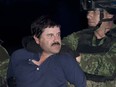 In this Jan. 8, 2016, file photo, Mexican drug lord Joaquin "El Chapo" Guzman is made to face the press as he is escorted to a helicopter in handcuffs by Mexican soldiers and marines at a federal hangar in Mexico City, Mexico.