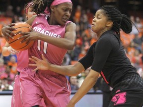 Louisville's Arica Carter, right, put pressure on Syracuse's Gabrielle Cooper, left, in the first quarter of an NCAA college basketball game in Syracuse, N.Y., Sunday, Feb. 4, 2018.