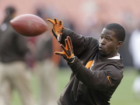 FILE - This Dec. 16, 2012 file photo shows Cleveland Browns wide receiver Mohamed Massaquoi warming up before the Browns play the Washington Redskins in an NFL football game in Cleveland. Massaquoi revealed for the first time that he lost most of his left hand in an ATV accident last April. Massaquoi, who starred at Georgia before going to the NFL, was riding with friends when he crashed and was badly injured. Doctors attempted to save his hand, but were only able to keep his thumb.