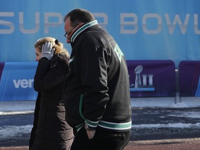 FILE - In this Feb. 4, 2018 file photo fans brave cold temperatures as they make their way to U.S. Bank Stadium for the NFL Super Bowl 52 football game between the Philadelphia Eagles and the New England Patriots in Minneapolis. The extreme cold that settled over Minneapolis during the Super Bowl has some wondering if the NFL's marquee event will ever return. Despite some complaints about the weather, many who attended say it wasn't a negative. The NFL has used the Super Bowl as a reward for municipalities that pump public money into new venues. The next four Super Bowls will be held at warm-weather sites, all of them with new or recently renovated stadiums.