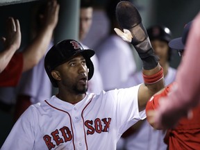 FILE - This Aug. 15, 2017 file photo shows Boston Red Sox's Eduardo Nunez celebrating with teammates during a baseball game against the St. Louis Cardinals in Boston. The Red Sox have re-signed Nunez to a one-year contract with a player option for 2019, giving them another proven second baseman to fill in while Dustin Pedroia recovers from knee surgery. Nunez's deal was done on Sunday, Feb. 18, 2018, the day before the Red Sox hold their first full-squad workout of spring training.