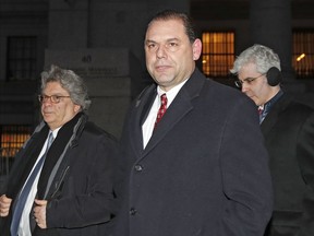 FILE - In this Feb. 1, 2018 file photo, Joseph Percoco, center, one of Gov, Andrew Cuomo's former executive deputy secretary, leaves U.S. District court with attorney Barry Bohrer, left, and others after appearing in his federal bribery trial in New York. Percoco has pleaded not guilty. His lawyers say his legal acts are being falsely portrayed as crimes by the government's star witness, Todd Howe.