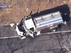 In this image made from video provided by WCBS-TV News, a damaged oil truck sits on the side of the highway after it was involved in a fatal accident, Wednesday, Feb. 14, 2018 in Ridge, N.Y. Authorities say that several people died in the accident involving a stolen car, an oil truck and two other vehicles. (WCBS-TV News via AP)