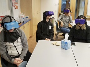 In this Feb. 7, 2018 photo, students at the Berkeley Carroll School in the Brooklyn borough of New York use virtual reality headsets in their classroom. Experts say the technology is still relatively rare in schools, but they expect that to change as costs come down and content improves. Seated at the table from left are Daniel Cornicello, 17, Charlie Hertz, 17, and Taylor Engler, 16. At the table in the back of the room is Angela Aguero, 17.