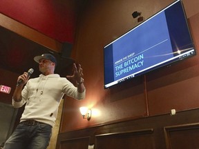 In this Feb. 7, 2018, photo, Jeff Hanzlik delivers a presentation about bitcoin at a bitcoin meet-up group at a restaurant in Hillsboro, Ore. Hanzlik, of Portland, was an early adopter of bitcoin and uses it to make purchases online and in stores.