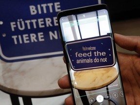 In this Feb. 21, 2018, photo, the Bixby virtual assistant software of a Samsung Galaxy S9 Plus mobile phone translates a foreign language sign during a product preview in New York. The Galaxy S9 phones were unveiled Sunday, Feb. 25, in Barcelona, Spain, and will be available March 16. Advance orders begin this Friday.