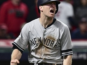 FILE - In this Wednesday, Oct. 11, 2017, file photo, New York Yankees' Todd Frazier celebrates after scoring in the ninth inning against the Cleveland Indians in Game 5 of a baseball American League Division Series, in Cleveland. On Monday, Feb. 5, 2018, a person familiar with the deal tells The Associated Press that free agent third baseman Todd Frazier and the New York Mets have agreed on a two-year contract for $17 million.