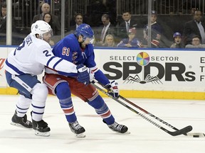 FILE - In a Saturday, Dec.23, 2017 file photo, Toronto Maple Leafs defenseman Ron Hainsey (2) checks New York Rangers right wing Rick Nash (61) as he controls the puck during the second period of an NHL hockey game at Madison Square Garden in New York. On Sunday, Feb. 25, 2018, the New York Rangers traded forward Rick Nash as part of a multiplayer deal with the Boston Bruins. The Rangers acquired the Bruins' first-round pick in this year's draft as well as forwards Ryan Spooner and Matt Beleskey and a seventh-round pick in the 2019 draft.