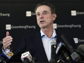 Former Louisville basketball coach Rick Pitino talks to reporters during a news conference in New York, Wednesday, Feb. 21, 2018. Pitino helds the news conference in the wake of an NCAA decision in a sex scandal case that strips the Cardinals program of 123 victories, a national championship and $600,000 in post-season revenue.