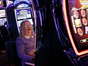 Helen Solcberg plays a video slot machine at the public opening of Resorts World Catskills in Monticello, N.Y., Thursday, Feb. 8, 2018.  The casino is opening Thursday in the heart of the old "Borscht Belt." It will feature more than 150 table games and 2,150 slot machines about 80 miles northwest of New York City. Promoted as economic boost to this old resort area, it is opening in an increasingly competitive regional market.