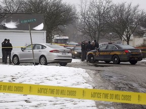 Authorities investigate the scene of a shooting where two Westerville, Ohio, police officers were shot and killed responding to a hang-up 911 call, on Saturday, Feb. 10, 2018. Officers Eric Joering and Anthony Morelli were shot around noon after entering the residence in the Columbus suburb.