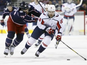 Washington Capitals' Chandler Stephenson, right, carries the puck up ice as Columbus Blue Jackets' David Savard defends during the first period of an NHL hockey game Tuesday, Feb. 6, 2018, in Columbus, Ohio.