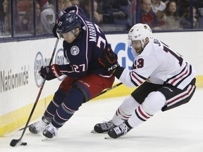 Columbus Blue Jackets' Ryan Murray, left, controls the puck as Chicago Blackhawks' Tomas Jurco, of Slovakia, defends during the first period of an NHL hockey game Saturday, Feb. 24, 2018, in Columbus, Ohio.