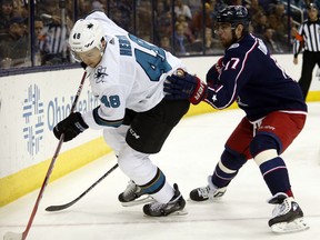 San Jose Sharks forward Tomas Hertl, left, of the Czech Republic, chases the puck next to Columbus Blue Jackets forward Brandon Dubinsky during the first period of an NHL hockey game in Columbus, Ohio, Friday, Feb. 2, 2018.