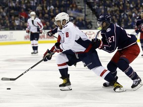 Washington Capitals forward Alex Ovechkin, left, of Russia, controls the puck against Columbus Blue Jackets defenseman Ryan Murray during the first period of an NHL hockey game in Columbus, Ohio, Monday, Feb. 26, 2018.