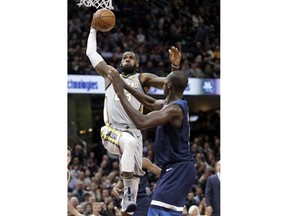 Cleveland Cavaliers' LeBron James, left, drives to the basket against Minnesota Timberwolves' Gorgui Dieng, from Senegal, in the first half of an NBA basketball game, Wednesday, Feb. 7, 2018, in Cleveland.