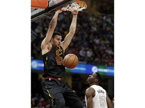 Cleveland Cavaliers' Larry Nance Jr. (24) dunks against Washington Wizards' Ian Mahinmi (28) in the first half of an NBA basketball game, Thursday, Feb. 22, 2018, in Cleveland.