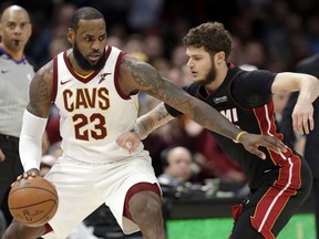 Cleveland Cavaliers' LeBron James drives past Miami Heat's Tyler Johnson in the second half of an NBA basketball game, Wednesday, Jan. 31, 2018, in Cleveland. The Cavaliers won 91-89.