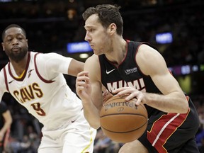 Miami Heat's Goran Dragic (7), from Slovenia, drives past Cleveland Cavaliers' Dwyane Wade (9) in the second half of an NBA basketball game, Wednesday, Jan. 31, 2018, in Cleveland. The Cavaliers won 91-89.