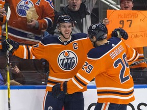 Edmonton Oilers captain Connor McDavid is congratulated by teammate Leon Draisaitl after scoring one of his four goals on the night in a 6-2 win over the Tampa Bay Lightning Monday at Rogers Place. McDavid added an assist for a five-point night.