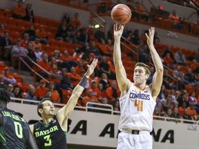Oklahoma State forward Mitchell Solomon pulls up for a shot during an NCAA college basketball game against Baylor on Tuesday, Feb. 6, 2018 in Stillwater Okla.