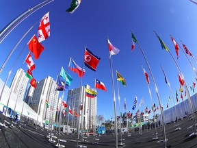 The North Korean flag (centre) flies at the Olympic Village in Pyeongchang on Feb. 1.