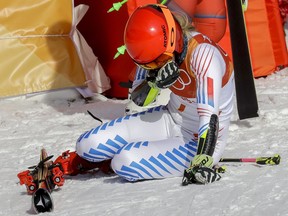 Mikaela Shiffrin, of the United States, falls to her knees after winning the gold medal in the Women's Giant Slalom at the 2018 Winter Olympics in Pyeongchang, South Korea, Thursday, Feb. 15, 2018., Thursday, Feb. 15, 2018.