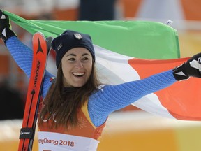Gold medal winner Sofia Goggia, of Italy, celebrates during the flower ceremony for the women's downhill at the 2018 Winter Olympics in Jeongseon, South Korea, Wednesday, Feb. 21, 2018.