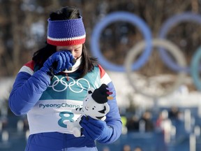 Marit Bjoergen, of Norway, wipes a tear away after winning the gold medal in the women's 30k cross-country skiing competition at the 2018 Winter Olympics in Pyeongchang, South Korea, Sunday, Feb. 25, 2018.