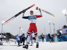 Simen Hegstad Krueger, of Norway, celebrates after winning the during the men's 15km/15km skiathlon cross-country skiing competition at the 2018 Winter Olympics in Pyeongchang, South Korea, Sunday, Feb. 11, 2018.