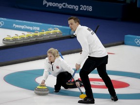 FILE - In this Feb. 13, 2018 file photo, Norway's Kristin Skaslien, left, throws the stone as teammate Magnus Nedregotten looks on during the mixed doubles bronze medal curling match against Russian athletes Anastasia Bryzgalova and Alexander Krushelnitsky at the 2018 Winter Olympics in Gangneung, South Korea. Nedregotten and his partner, who lost out on the Olympic bronze medal to Krushelnitsky,  charged with doping, said Tuesday, Feb. 20  he feels robbed of his moment of glory.