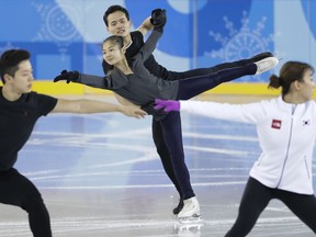 North Korea's Ryom Tae Ok and Kim Ju Sik, center, practice next to South Korea's Kim Kyu-eun, front right, and Alex Kam during a pairs figure skating training session prior to the 2018 Winter Olympics in Gangneung, South Korea, Monday, Feb. 5, 2018.