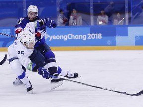 Jonathon Blum (24), of the United States, defends Jan Urbas (26), of Slovenia, during the first period of the preliminary round of the men's hockey game at the 2018 Winter Olympics in Gangneung, South Korea, Wednesday, Feb. 14, 2018.