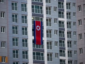 A large North Korean flag hangs from an apartment building at the Olympic Village prior to the 2018 Winter Olympics in Gangneung, South Korea, Friday, Feb. 2, 2018.