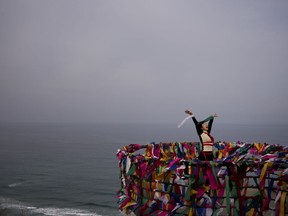 Artist Doyu, 48, performs at the Goseong Unification Observatory as part of an art festival in Goseong, South Korea, Monday, Feb. 19, 2018. "I'd like to express a bird who wants to fly wherever it wants without having any boundary," said the performer. Located just south of the DMZ, the observatory is one of northernmost points in South Korea where civilians can travel to have a glimpse into North Korea.