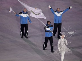 Dinos Lefkaritis carries the flag of Cyprus during the opening ceremony of the 2018 Winter Olympics in Pyeongchang, South Korea, Friday, Feb. 9, 2018.