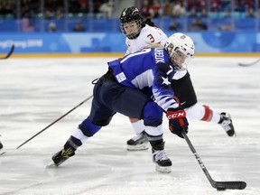 Monique Lamoureux-Morando (7), of the United States, skates with the puck against Jocelyne Larocque (3), of Canada, during the first period of the women's gold medal hockey game at the 2018 Winter Olympics in Gangneung, South Korea, Thursday, Feb. 22, 2018.