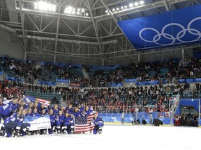 Untied States hockey team pose after beating Canada in the women's gold medal hockey game at the 2018 Winter Olympics in Gangneung, South Korea, Thursday, Feb. 22, 2018.