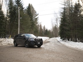 An Ontario Provincial Police cruiser blocks the scene of what police are investigating as a triple murder-suicide about 300 kilometres north of Toronto, in Ryerson Township, Ont., on Sunday, February 25, 2018.