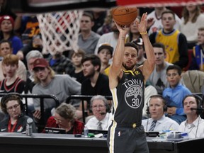 Golden State Warriors guard Stephen Curry takes an open jump shot against the Portland Trail Blazers during the first half of an NBA basketball game in Portland, Ore., Wednesday, Feb. 14, 2018.
