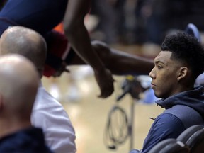Arizona guard Allonzo Trier, right, sits courtside as teammates warm up before an NCAA college basketball game against Oregon State in Corvallis, Ore., Thursday, Feb. 22, 2018. Trier has been ruled ineligible by the NCAA for a positive test for performance enhancing drugs. Arizona is appealing the suspension.