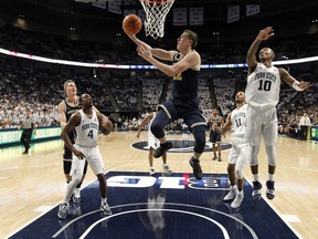 Michigan's Duncan Robinson (22) makes a basket against Penn State during the first half of an NCAA college basketball game in State College, Pa., Wednesday, Feb. 21, 2018.