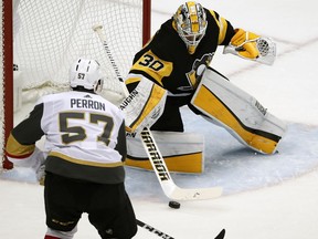 Pittsburgh Penguins goaltender Matt Murray (30) stops a shot by Vegas Golden Knights' David Perron (57) during the first period of an NHL hockey game in Pittsburgh, Tuesday, Feb. 6, 2018.