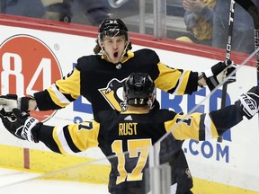 Pittsburgh Penguins' Carl Hagelin, rear, celebrates his goal during the first period of an NHL hockey game against the Toronto Maple Leafs in Pittsburgh, Saturday, Feb. 17, 2018.