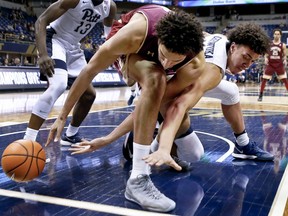 Boston College's Johncarlos Reyes, center, and Pittsburgh's Kene Chukwuka, right, chase the ball during the first half of an NCAA college basketball game Tuesday, Feb. 13, 2018, in Pittsburgh.