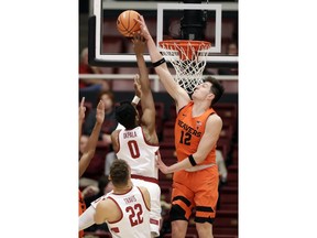 Oregon State forward Drew Eubanks (12) blocks a shot from Stanford forward Kezie Okpala (0) during the first half of an NCAA college basketball game Thursday, Feb. 1, 2018, in Stanford, Calif.