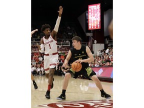 Oregon guard Payton Pritchard, right, is guarded by Stanford guard Daejon Davis (1) during the first half of an NCAA college basketball game Saturday, Feb. 3, 2018, in Stanford, Calif.