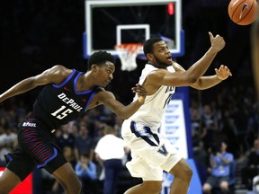 Villanova forward Omari Spellman (14) and DePaul forward Paul Reed (15) chase the ball during the first half of an NCAA college basketball game Wednesday, Feb. 21, 2018, in Philadelphia.